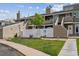 Inviting townhome featuring a well-maintained front yard with a white picket fence and exterior stairs at 8095 E Colorado Ave # 5, Denver, CO 80231