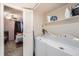 Convenient laundry area with stacked washer/dryer, shelf, and easy access to a bedroom at 8095 E Colorado Ave # 5, Denver, CO 80231