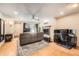Spacious living room with wood flooring, a fireplace, a comfortable couch, and modern ceiling fan at 8095 E Colorado Ave # 5, Denver, CO 80231