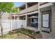Cozy, covered patio with outdoor seating, a well-kept garden bed, and a white picket fence at 8095 E Colorado Ave # 5, Denver, CO 80231