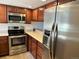 Modern kitchen with stainless steel appliances and sleek countertops at 10 S Nome St # E, Aurora, CO 80012