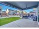 A view from under the covered patio area overlooking the landscaped backyard and neighboring homes at 6801 S Valleyhead Ct, Aurora, CO 80016