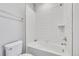 Clean white tiled shower/tub combination with modern fixtures, offering a bright and functional space at 6801 S Valleyhead Ct, Aurora, CO 80016
