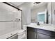 Modern bathroom featuring a glass shower, dark wood vanity with white countertops and black accents at 6801 S Valleyhead Ct, Aurora, CO 80016