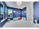 Stylish bedroom with a solar system accent wall, ample natural light, and neutral carpeting at 6801 S Valleyhead Ct, Aurora, CO 80016