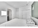 Bright bedroom features fresh white walls and trim and a closet with sliding doors at 6801 S Valleyhead Ct, Aurora, CO 80016