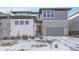 Charming home showcasing a two-car garage, stone accents, and manicured landscaping at 6801 S Valleyhead Ct, Aurora, CO 80016