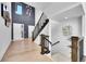Bright foyer featuring soaring ceilings, modern lighting, and beautiful hardwood floors at 6801 S Valleyhead Ct, Aurora, CO 80016