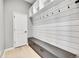 Mud room with built-in storage bench, hooks, overhead shelves and access to the garage at 6801 S Valleyhead Ct, Aurora, CO 80016