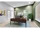 Office features desk, shelving, bright window, and ample space at 6801 S Valleyhead Ct, Aurora, CO 80016