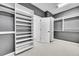 Spacious walk-in closet with custom shelving and gray walls providing ample storage and organization at 6801 S Valleyhead Ct, Aurora, CO 80016