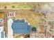 An aerial shot exhibits a spacious backyard, garden beds, a playset, and the home's proximity to neighbors at 740 Boxwood Ln, Longmont, CO 80503