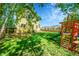 Expansive backyard provides ample space, lush grass, a play set, and a privacy fence, creating a Gathering-friendly area at 740 Boxwood Ln, Longmont, CO 80503