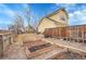 Large backyard with garden beds and wooden fence at 740 Boxwood Ln, Longmont, CO 80503