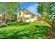 Lush backyard featuring a well-manicured lawn and mature trees at 740 Boxwood Ln, Longmont, CO 80503