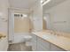 Well-lit bathroom showcases a shower-tub combination, single sink vanity, and tile flooring for easy maintenance at 740 Boxwood Ln, Longmont, CO 80503