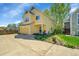 Charming yellow two-story home with a well-maintained lawn and attached garage at 740 Boxwood Ln, Longmont, CO 80503