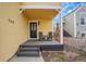 Charming covered porch featuring black chairs and a freshly painted black floor at 740 Boxwood Ln, Longmont, CO 80503