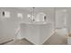 Bright hallway features three windows, white walls, and a modern light fixture, creating an inviting transition space at 740 Boxwood Ln, Longmont, CO 80503