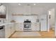 Well-equipped kitchen features stainless appliances, white cabinets and a vintage refrigerator at 740 Boxwood Ln, Longmont, CO 80503