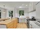Bright, open kitchen featuring a large island, stainless steel appliances, and natural light at 740 Boxwood Ln, Longmont, CO 80503