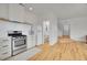 Modern kitchen with stainless steel appliances, light cabinets, and hardwood floors at 740 Boxwood Ln, Longmont, CO 80503