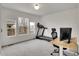 Bright office with desk, treadmill, and windows offering outdoor views, perfect for a productive workspace at 740 Boxwood Ln, Longmont, CO 80503
