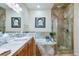 This stylish bathroom has double sinks, a shower with a glass enclosure, and tile flooring at 15501 E 112Th Ave # 20C, Commerce City, CO 80022