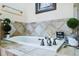 Stylish bathroom featuring a soaking tub with tile surround and modern fixtures at 15501 E 112Th Ave # 20C, Commerce City, CO 80022