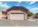 Attached two-car garage with a white door and well-maintained landscaping at 15501 E 112Th Ave # 20C, Commerce City, CO 80022