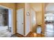 Bright hallway with hardwood floors leading to a bathroom and living area at 15501 E 112Th Ave # 20C, Commerce City, CO 80022