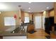 Eat-in kitchen with breakfast bar, modern cabinets, and hardwood flooring at 15501 E 112Th Ave # 20C, Commerce City, CO 80022