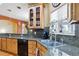 The kitchen showcases granite countertops, wood cabinetry, a stainless steel sink, and a view from the window at 15501 E 112Th Ave # 20C, Commerce City, CO 80022