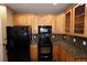 Kitchen features wooden cabinetry, granite counters, and modern appliances at 15501 E 112Th Ave # 20C, Commerce City, CO 80022