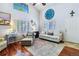 Bright living room with natural light, stylish furniture and a decorative wall clock at 15501 E 112Th Ave # 20C, Commerce City, CO 80022