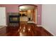 Open-concept living room with hardwood floors, fireplace, and view into the kitchen at 15501 E 112Th Ave # 20C, Commerce City, CO 80022