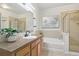 Well-lit bathroom featuring a shower, bath, and vanity with modern fixtures at 13456 Via Varra # 211, Broomfield, CO 80020