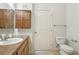 Bathroom featuring a toilet, vanity, medicine cabinet, and sleek fixtures at 13456 Via Varra # 211, Broomfield, CO 80020