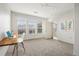 Bright bedroom with natural light, neutral carpet, desk, and three large windows at 13456 Via Varra # 211, Broomfield, CO 80020