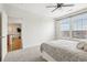 Bright bedroom features a ceiling fan, large windows, and neutral carpeting at 13456 Via Varra # 211, Broomfield, CO 80020