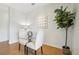 Cozy dining area with a glass table, upholstered chairs, a potted plant, and contemporary decor at 13456 Via Varra # 211, Broomfield, CO 80020