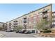 Multi-story condo building exterior with parking at 13456 Via Varra # 211, Broomfield, CO 80020