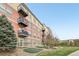 Multi-story condo building with stone and balcony at 13456 Via Varra # 211, Broomfield, CO 80020