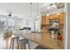 Bright open concept featuring an island with a sink, counter seating, and views of the living area at 13456 Via Varra # 211, Broomfield, CO 80020