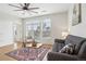 Cozy living room with a large window, ceiling fan, modern furniture, and a decorative area rug at 13456 Via Varra # 211, Broomfield, CO 80020