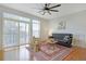 Bright living room featuring large windows, hardwood floors, ceiling fan, and comfortable seating arrangement at 13456 Via Varra # 211, Broomfield, CO 80020
