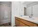 Bathroom featuring double sinks, wood cabinets, and a shower-tub combo at 3360 N Coolidge Way Way, Aurora, CO 80019