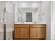 Bathroom with double sink vanity, white tile, and walk-in shower at 3360 N Coolidge Way Way, Aurora, CO 80019