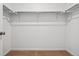 Walk-in closet featuring shelving and neutral carpet at 3360 N Coolidge Way Way, Aurora, CO 80019