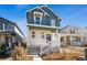 Charming two-story home featuring a welcoming front porch and blue siding on a sunny day at 3360 N Coolidge Way Way, Aurora, CO 80019